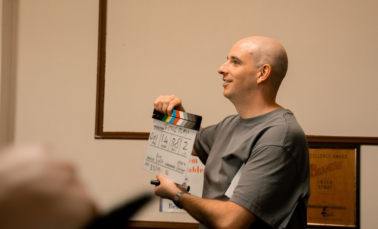 David Atkinson holding a film clapperboard on set